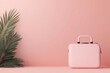 © AImagine Designs - Stylish pink travel bag beside lush green palm leaves against a soft pink background