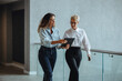 © Jacob Lund - Busy corporate morning: Executive assistant using a tablet to give her boss a briefing on her meetings and appointments.