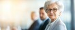 © Photography09 - Elderly woman in a corporate boardroom, standing confidently among male counterparts