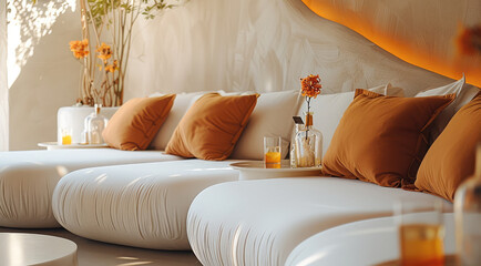 Relaxing at an event setting on a off-white cloud-like comfy couch with orange pillows while relaxing and enjoying wellness drinks. Generative AI.