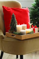 Wall Mural - Tray with burning candles and Christmas decor on armchair indoors