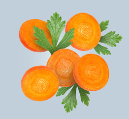 Wall Mural - Round carrot slices and parsley in air on grey background