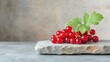 © cloud7days - Juicy currants arranged on a rugged stone podium, contrasting their rich color with the natural texture of the stone.