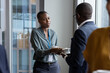 © ReeldealHD images - African American businesswoman shaking hands at a corporate networking event