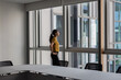 © ReeldealHD images - Businesswoman alone in an empty office conference room looking out of the window
