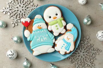 Wall Mural - Delicious cookies in shape of snowmen and Christmas decor on light grey table, flat lay