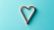 © Galib - Two intertwined copper heart shapes on a blue background.