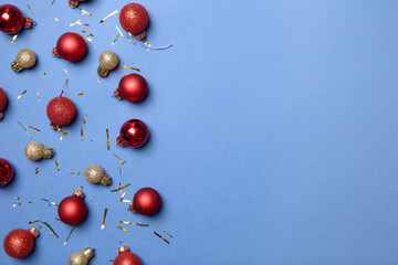 Poster - Flat lay composition with Christmas balls on blue background, space for text