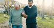 © David/peopleimages.com - Park, walking and caregiver with senior woman for assisted living, support and care in nature. Retirement, help and man with elderly person with disability outdoors for wellness, health and recovery