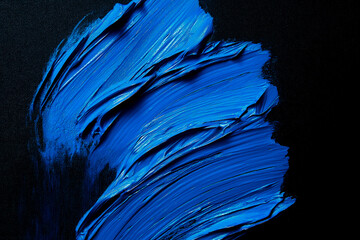 Wall Mural - bright blue brush stroke of paint on black background