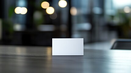 Wall Mural - Blank White Card on a Wooden Table with a Blurred Background