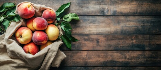 Fototapete - Eco friendly packaging zero waste for plastic shopping A lifestyle concept using recycled materials Fresh apples and peaches in a cloth bag Wooden boards backdrop copy space top view