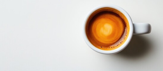 Beautiful texture on the espresso crema s surface in a cup on a white table close up Aroma of medium dark roasted Arabica coffee brewed as espresso Food and beverage photography with a minimalist sty