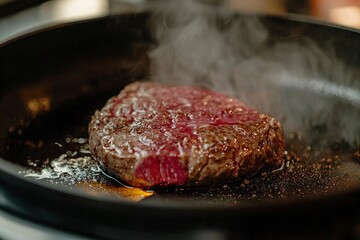 Sizzling Steak in a Black Pan with Steam Rising