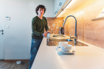 Young teens cooking together first time living together in their new apartment.