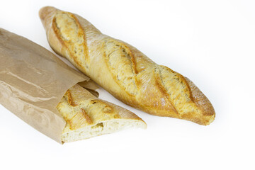 Two freshly baked baguettes, one wrapped in brown paper bag, Artisan French baguettes with crispy crusts in paper packaging. Isolated on a white background. Closeup. With clipping path. Copy space.