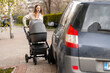 © Maria Vitkovska - Young mother having a mishap while pushing baby stroller on sidewalk
