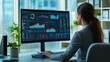 © saranya - businesswoman sit at desk with large, computer screen displaying financial data, including charts, graphs, and tables