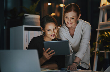 Office, women and happy at night with tablet for online research on deadline or overtime for project. People, employees and smile for teamwork, collaboration and coworking for business growth