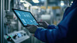 © Worakit - A worker is using tablet to monitor production quality in an industrial setting, showcasing advanced technology and attention to detail
