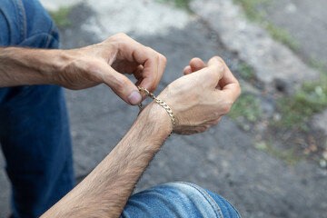 Male hand with a expensive bracelet. Fashion accessories and jewelry