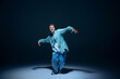 © master1305 - Dynamic image for young man in casual clothes in motion, dancing hip-hop against navy blue background. Shadows. Concept of freestyle dance, modernity, urban culture, youth