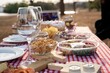 © Wirestock - Picnic table with snacks and wine glass.
