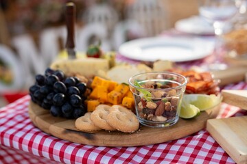 Close-up of a charcuterie board with assorted snacks outdoors