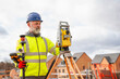 © Iryna - Construction Worker Surveying Land With Precision Equipment in a Developing Neighborhood