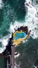 Wall Mural - Aerial vertical footage of Caloura natural swimming pool in Sao Miguel island, Azores, Portugal