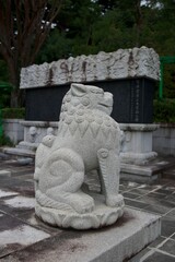 Wall Mural - Stone guardian lion statue at a temple