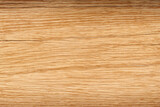 Close-up of a light brown wood grain texture with a natural pattern.