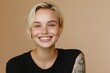 © MUdaylah - Young blond pretty smiling girl beauty female model with short blonde hair beautiful face healthy skin and tattoos looking at camera isolated at beige background. with generative ai
