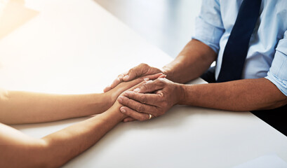 Holding hands, psychologist and patient for care, talking or communication for bad news, diagnosis or support. Doctor, medical discussion or comfort together for empathy, help or wellness in hospital