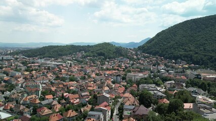 Wall Mural - Aerial footage of the cityscape of Brasov on a sunny day, in Transylvania region, Romania