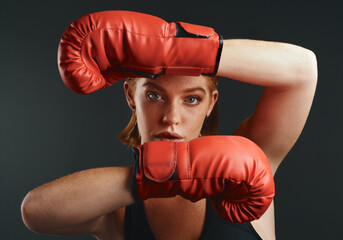 Woman, boxing gloves and portrait as professional boxer on studio background for fitness or challenge. Female person, athlete and power for fight with strong muscle or pride for championship in sport