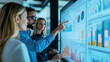 © Itsaraporn - A digital marketing team evaluating the effectiveness of current trends on a large touchscreen