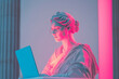 © eshana_blue - White statue of a woman wearing glasses working on a laptop illuminated with pink and blue lighting
