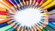 © pinporn manosri - A flat lay of colorful pencils, paints, and brushes arranged in a radial pattern on a white background
