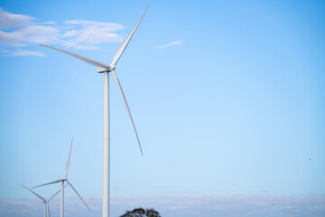 a group of wind turbines against blue sky, wind energy. wind power. sustainable, renewable energy. w