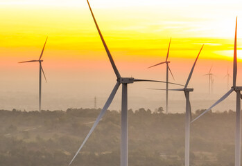 Wind farm field and sunset sky. Wind power. Sustainable, renewable energy. Wind turbines generate electricity. Sustainable development. Green technology for energy sustainability. Eco-friendly energy.