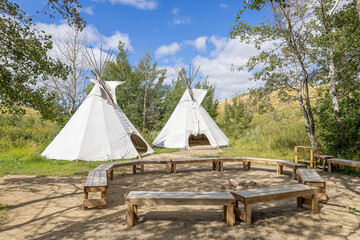 Two tipis and a circle benches at Wanuskewin Heritage Park in Saskatoon, Canada