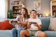 © ciric_velibor - Mother and Son Intently Focused While Playing Video Games