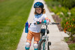 © Volodymyr - Kid ride bike. Child riding bicycle. Little kid boy in helmet on bicycle along bikeway. Happy cute little boy riding bicycle. Child in the protective helmet for bike cycling on bicycle.