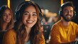 © I Have Photos - Smiling gamer woman with headphones in a group of friends at a gaming competition.