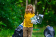 © Volodymyr - Kid in rubber gloves with trash bag clean up garbage on forest outdoor. Eco, environment conservation. Recycle pollution. Kid boy collecting garbage and plastic trash. Save environment. Eco kids.