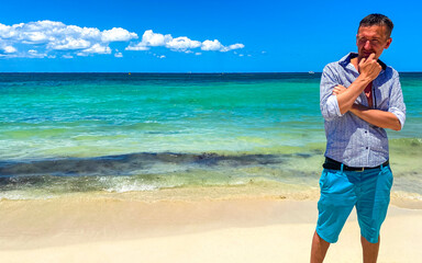 Male tourist man is having fun on Caribbean beach Mexico.