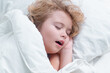 © Volodymyr - Boy is sleeping on the bed with his mouth open, snoring. Morning sleeping. Kid sleeping in bed. Child sleeping under blanket, lying on pillow. Child rest asleep, enjoy healthy sleep or nap.