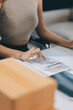 © ARMMY PICCA - Successful Woman start up online seller at workplace. small business entrepreneur SME or freelance asian woman working with box at home.