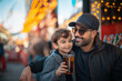 © lisbeth - Father and son enjoying family time together at amusement park
